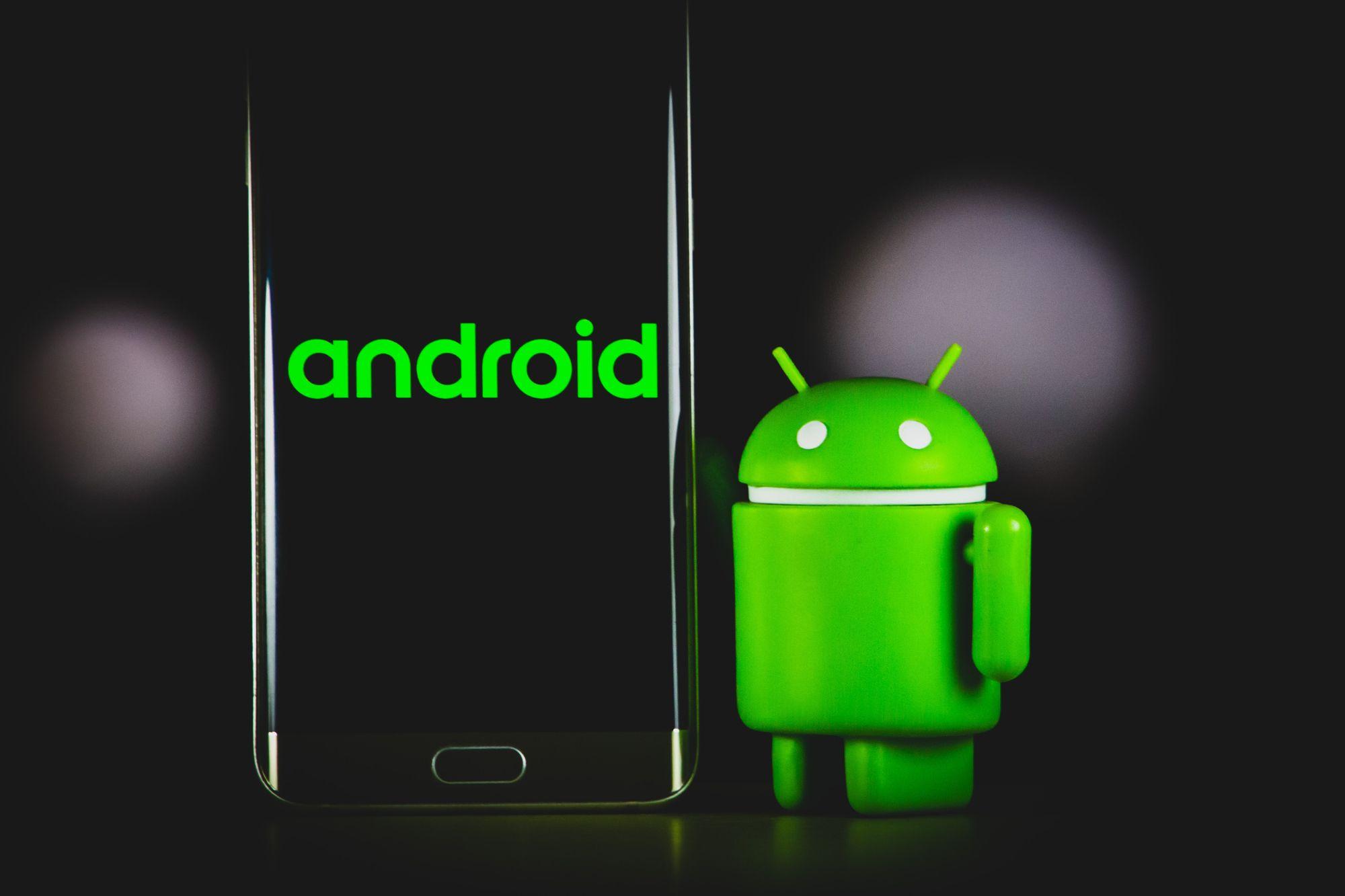 the android character poses with a phone